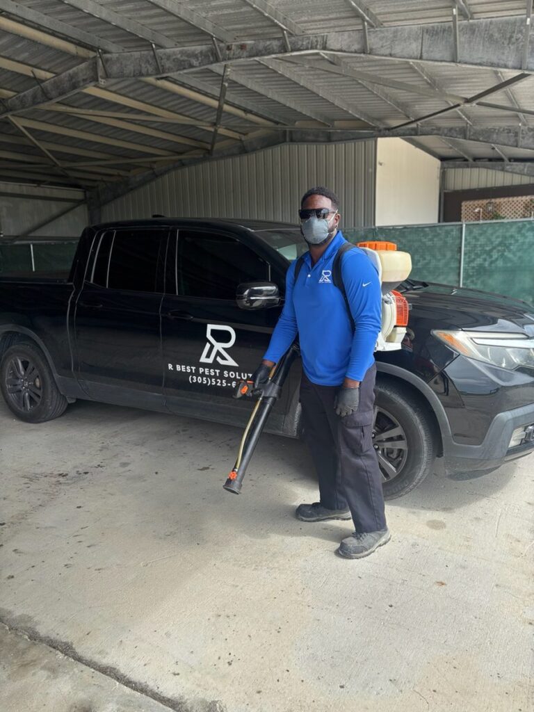 Doral pest control technician from R Best Pest Solutions with backpack sprayer and service truck