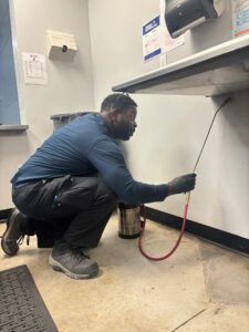 Commercial pest control Miami technician treating a restaurant kitchen